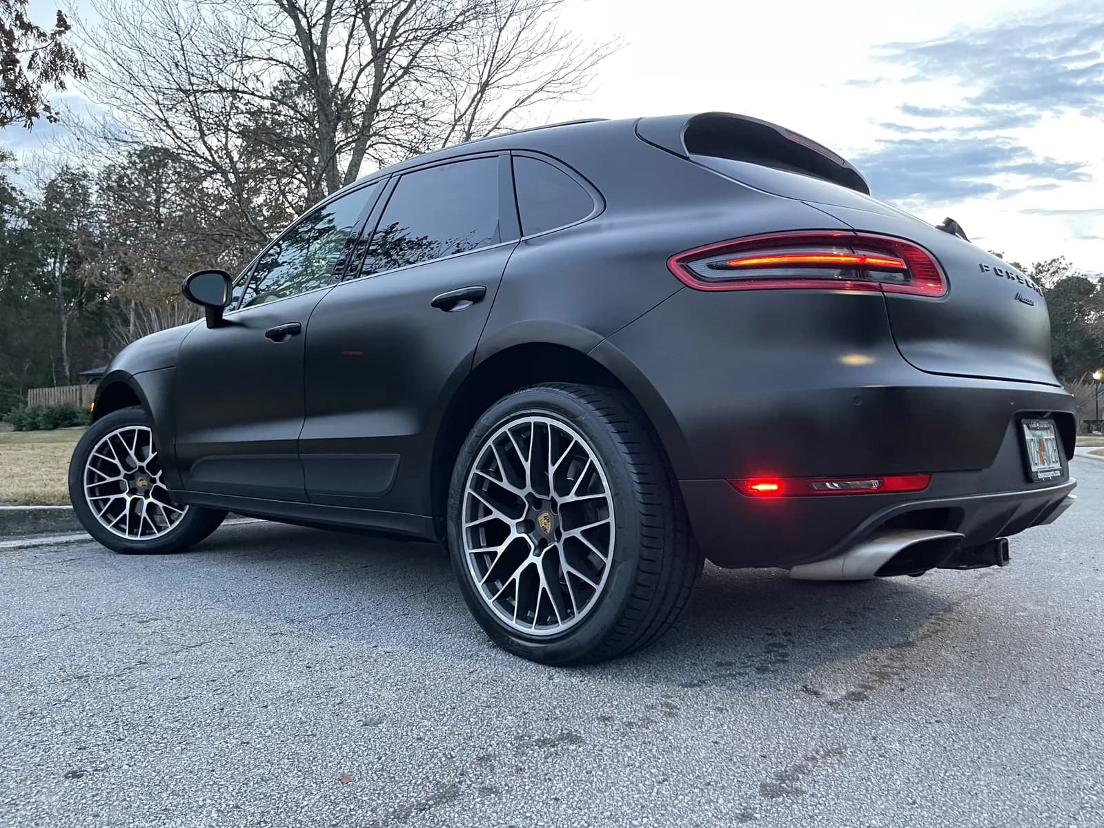 Porsche Macan wrapped in matte black, seen from the side