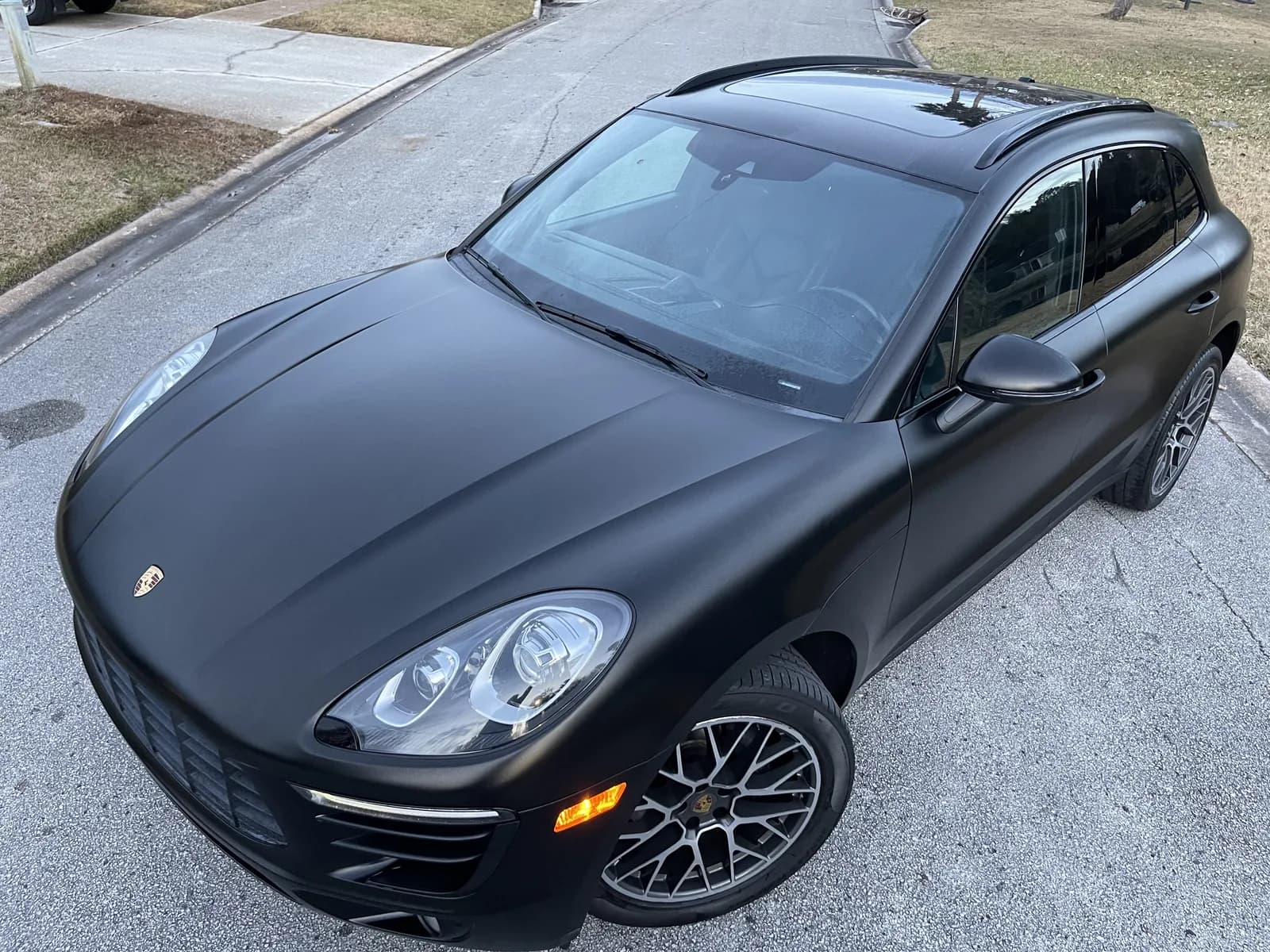 Front of a Porsche Macan wrapped in matte black
