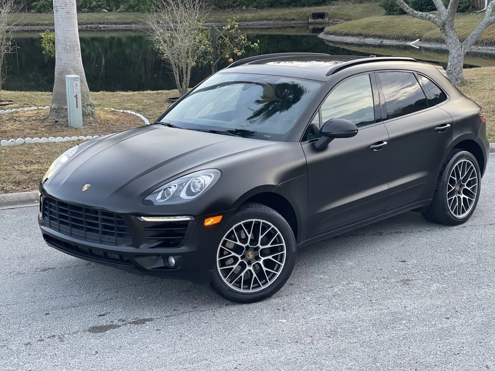 Porsche Macan wrapped in matte black, seen from the front quarter