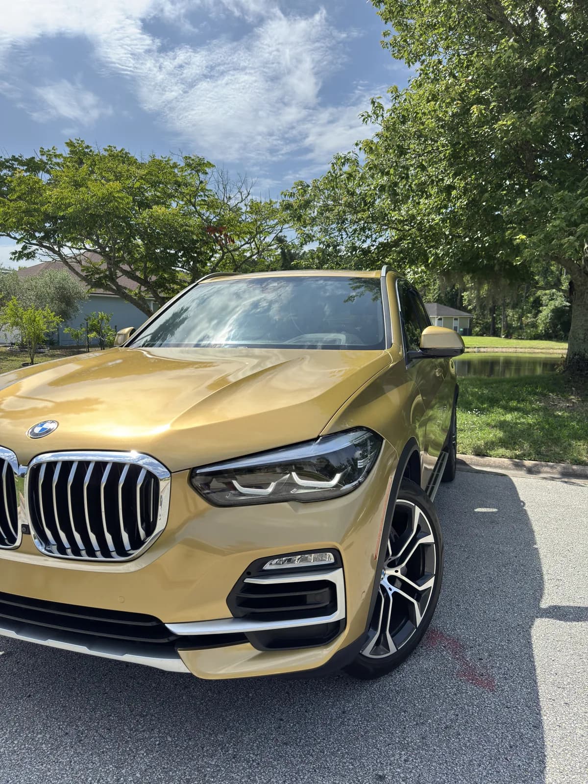 BMW X5 wrapped in gold, seen from the front quarter