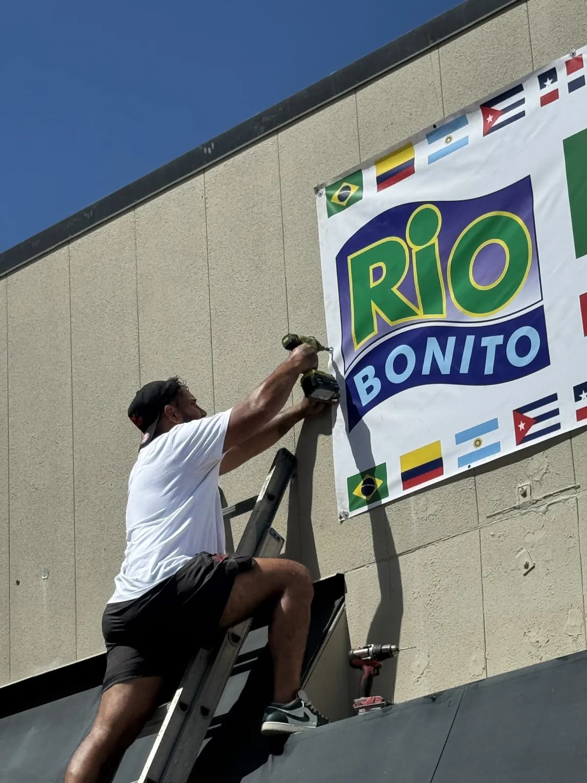 Banner being installed on the wall of a restaurant