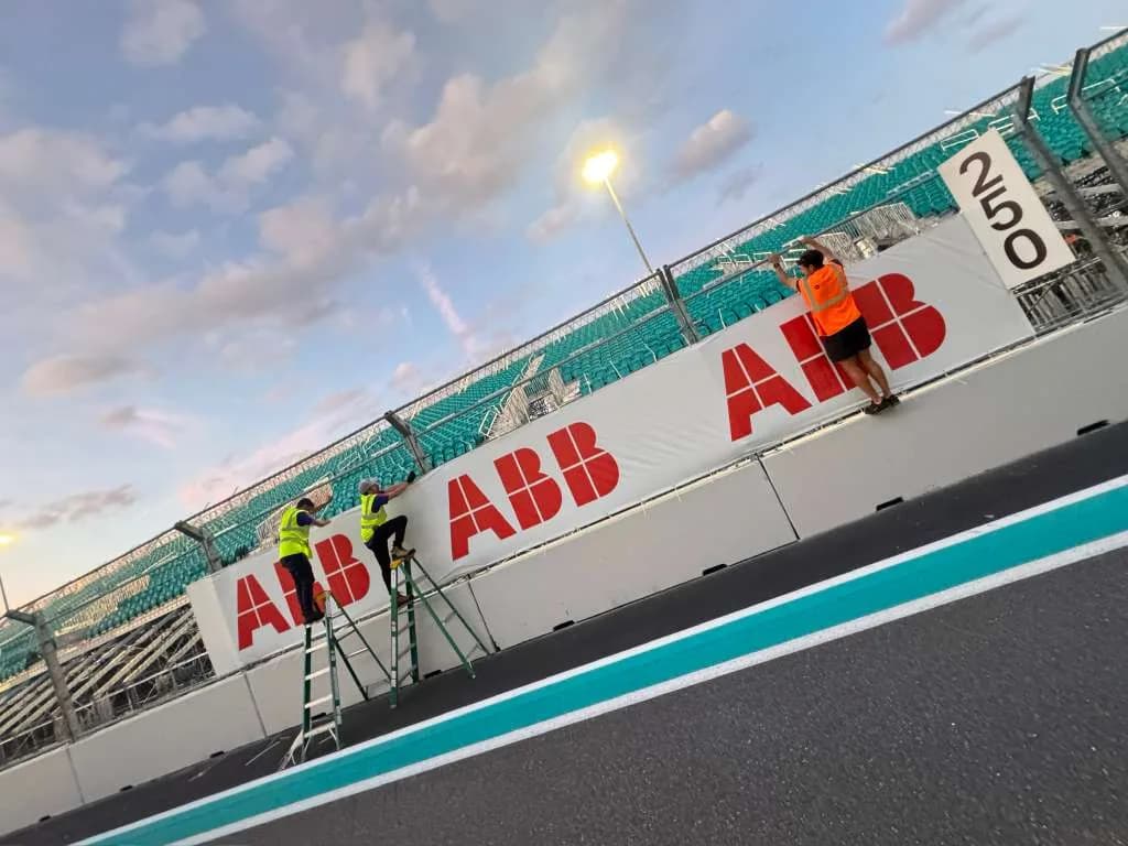 Large lettering being installed across the front of a building
