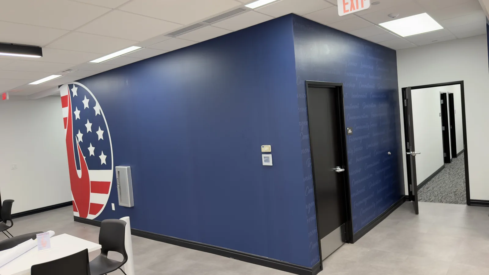 Office wall graphic with a flag mural next to a painted blue wall