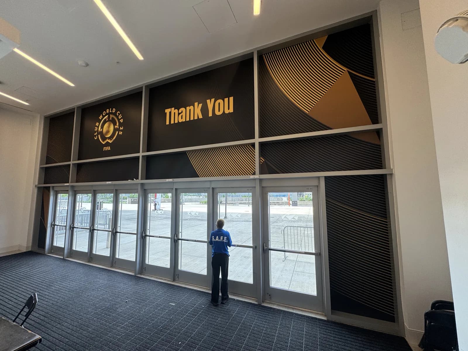 Large venue interior with gold lettering across the entrance wall