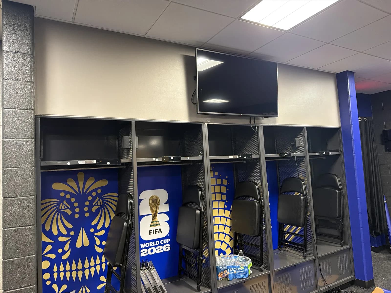 Locker room with printed team graphics and World Cup artwork on the lockers