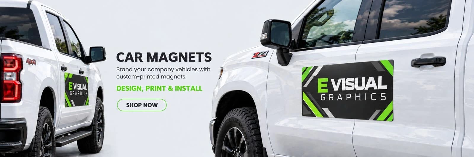 Car magnets applied to the doors of two white pickup trucks